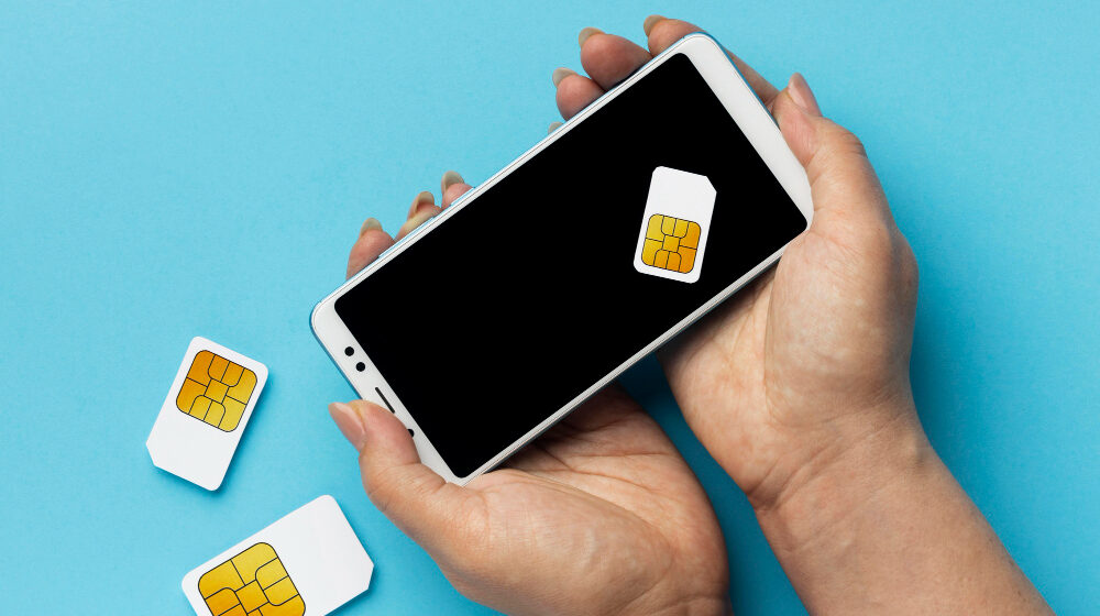 front-view-hands-holding-smartphone-sim-cards Unleash the Potential of eSIM: 5 Ways to Maximize its Efficiency